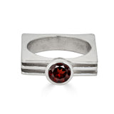 Geometric sterling silver ring with 6mm round garnet and three-layer square band design